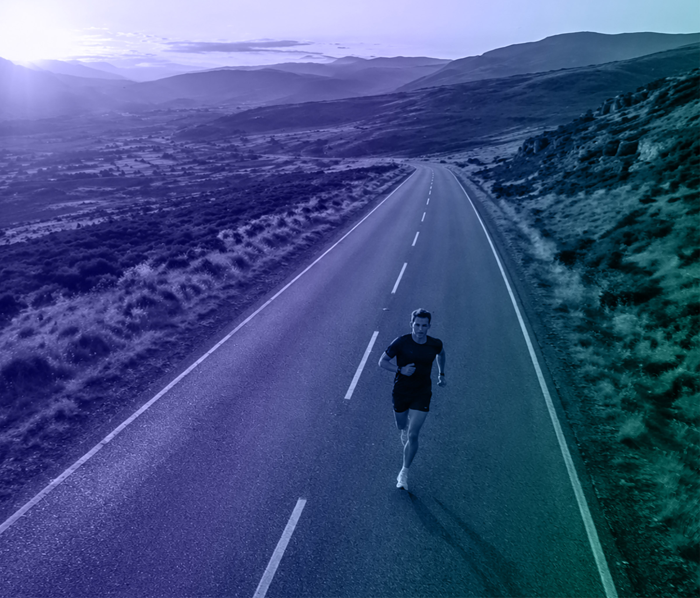 Runner on an open road through a remote mountainous landscape